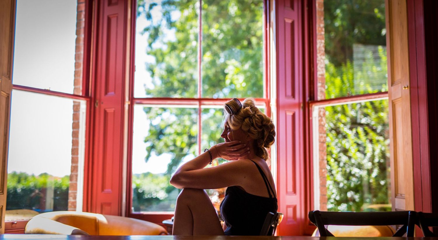 Red-framed windows create a panoramic view of natural outdoor scenery.