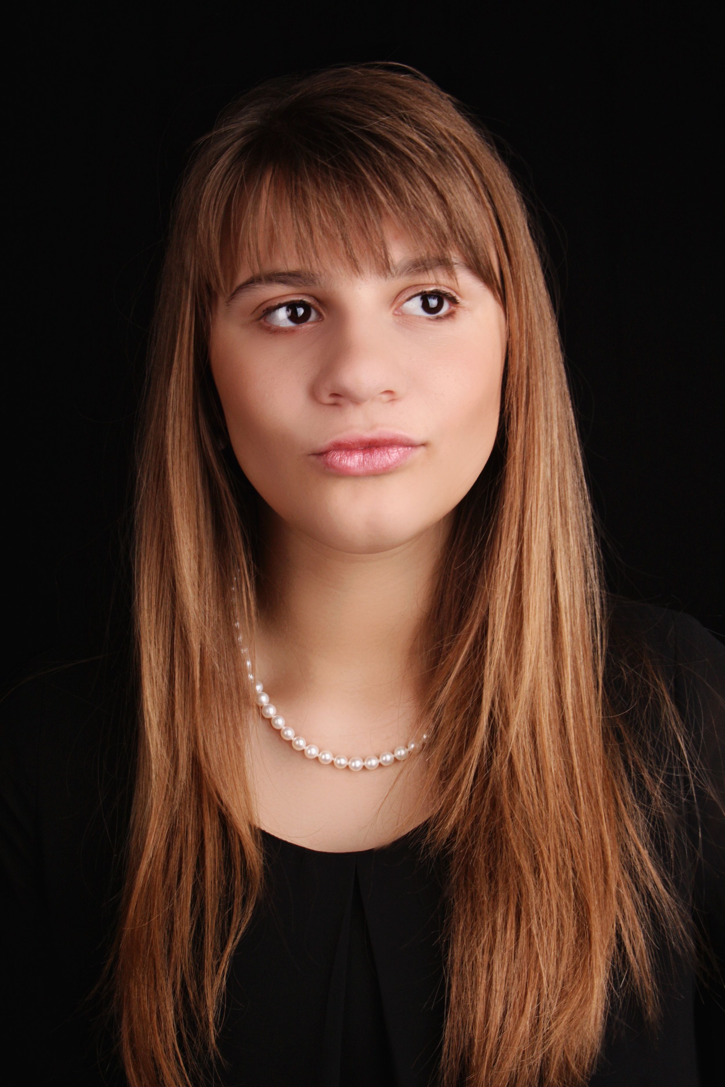 High school senior picture in studio on black