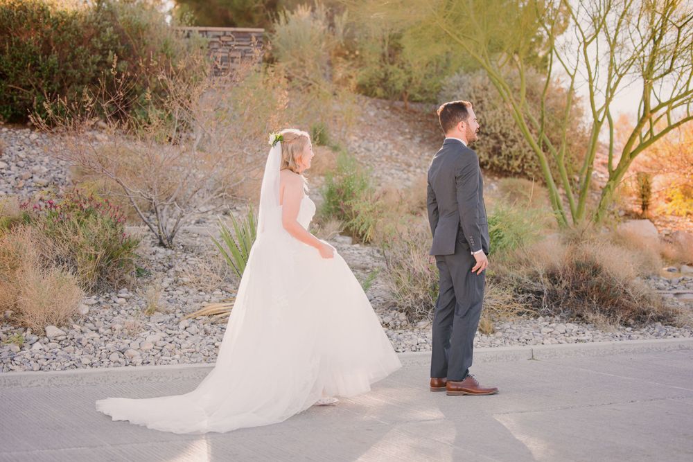 Bride and groom share intimate moment during desert sunset photo session.