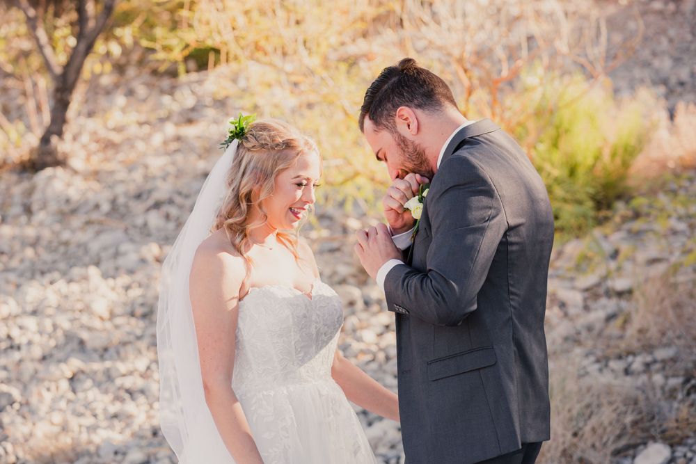 Wedding couple embracing during their outdoor desert photo session at sunset.