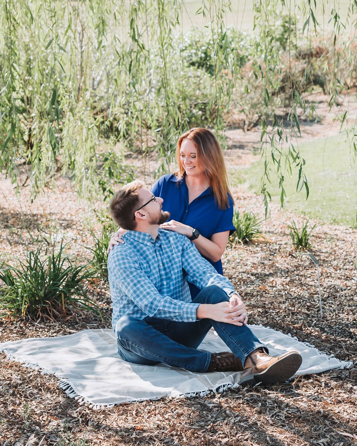 Image of a couple sitting on a blanket looking at each other from the Starkville Strong Fundraiser