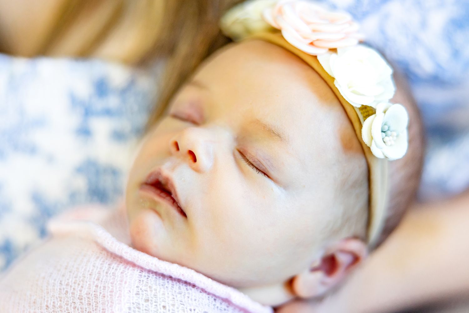 Close up of sleeping baby girl's face in her mom's arms during newborn photos in Colorado Springs.
