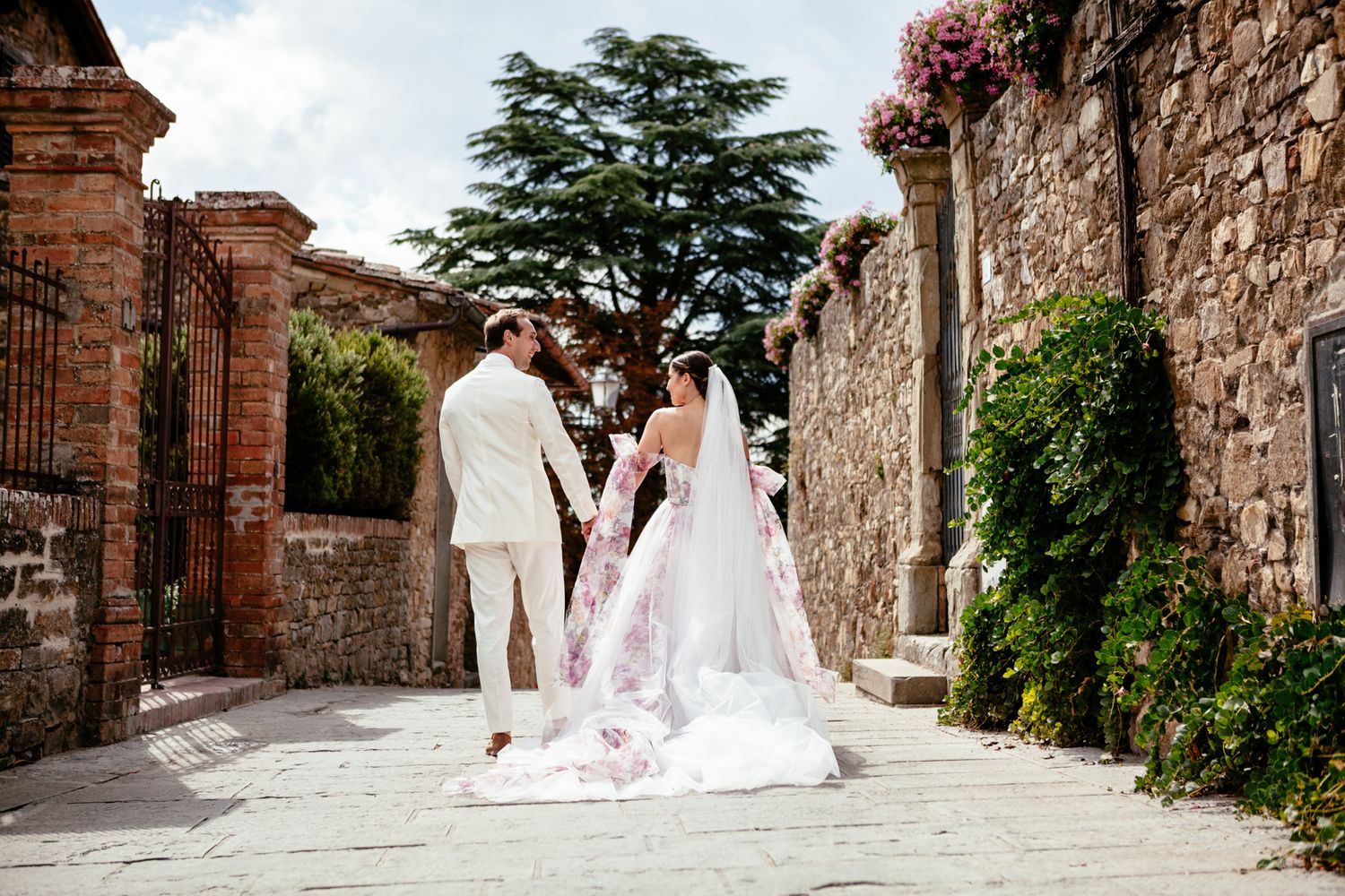 bride and groom walk down the cobbled lanes in Panzano Chianti Tuscany Italy