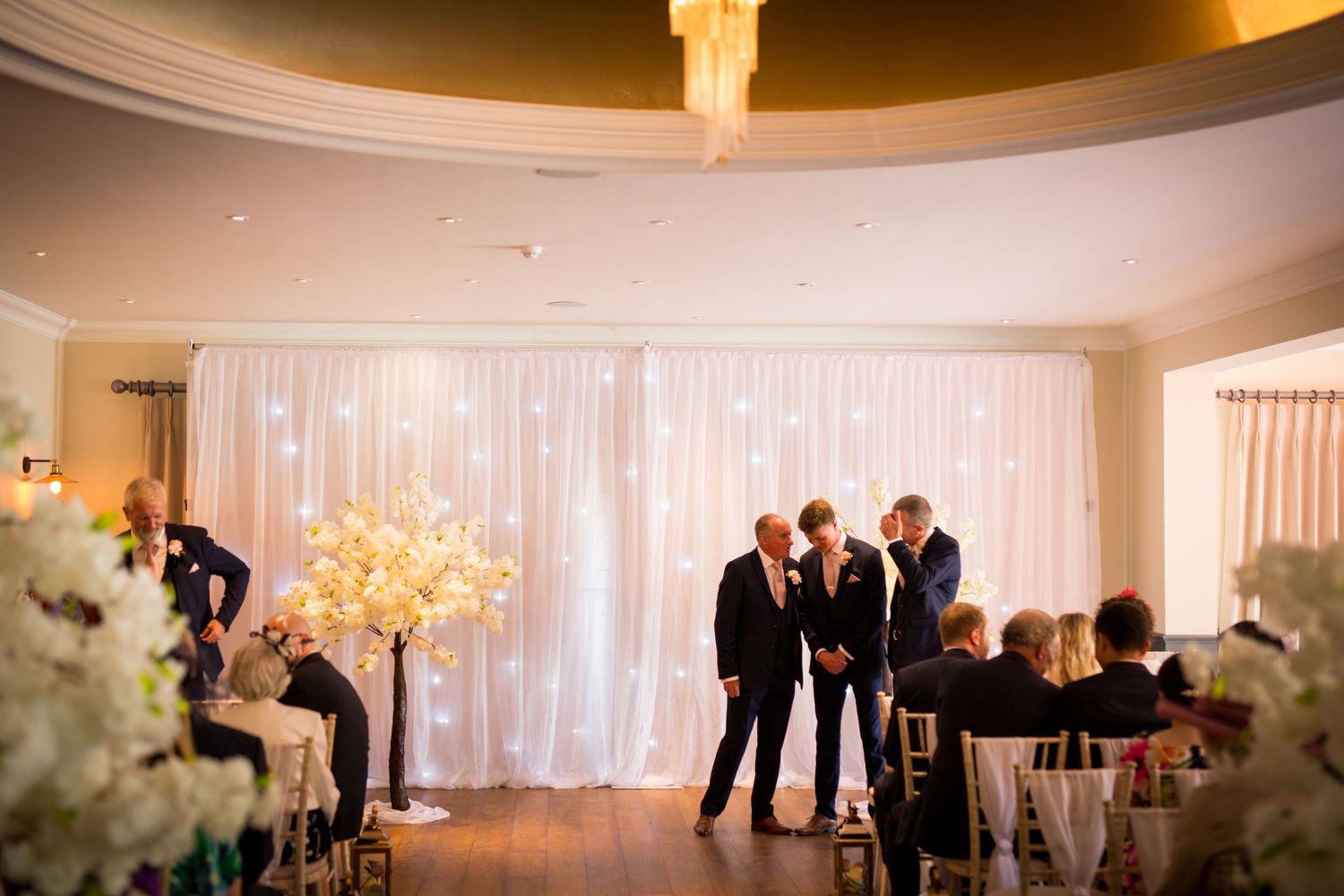 Wedding reception venue with elegant draping and ambient lighting.