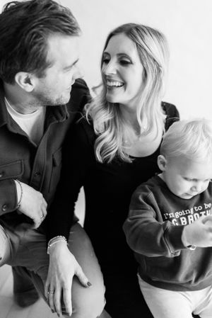 Black and white portrait of family sharing joyful moment together.