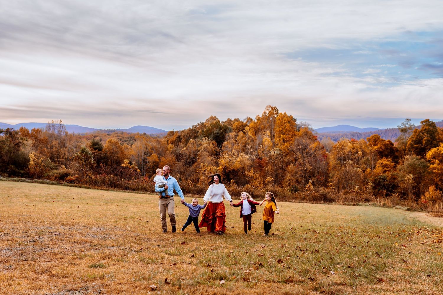family running up mountain side