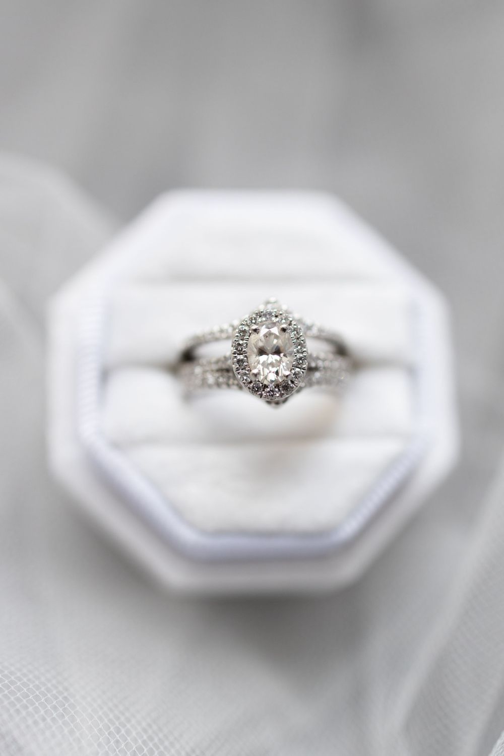 A stunning diamond engagement ring in a white octagonal ring box with soft lighting.