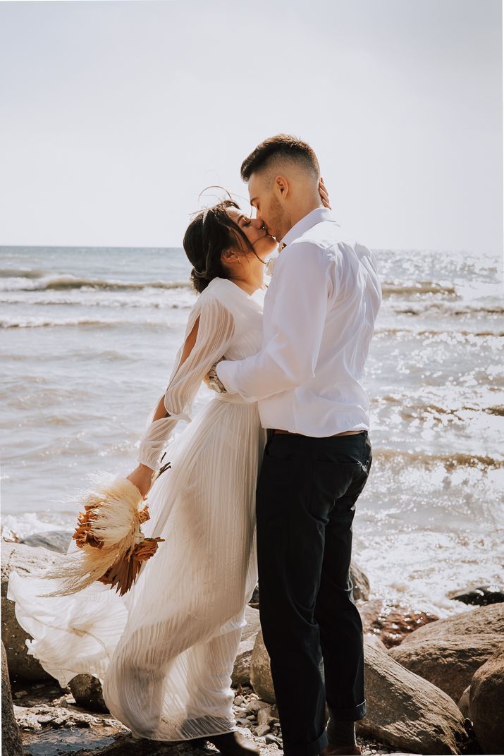 Bride and Groom first kiss after first look in beach front Toronto Canada