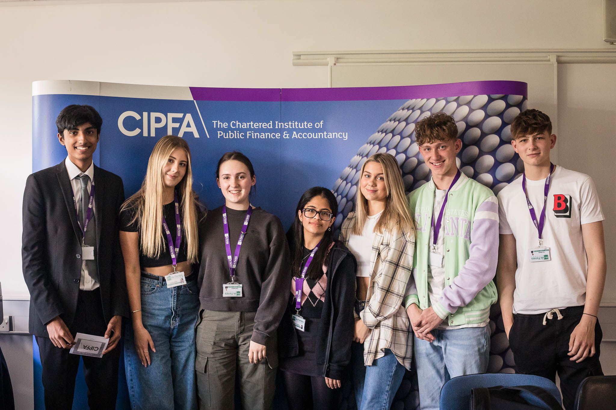 Image of students standing in front of a CIPFA banner having competed (and won) a CIPFA Midlands Management Game