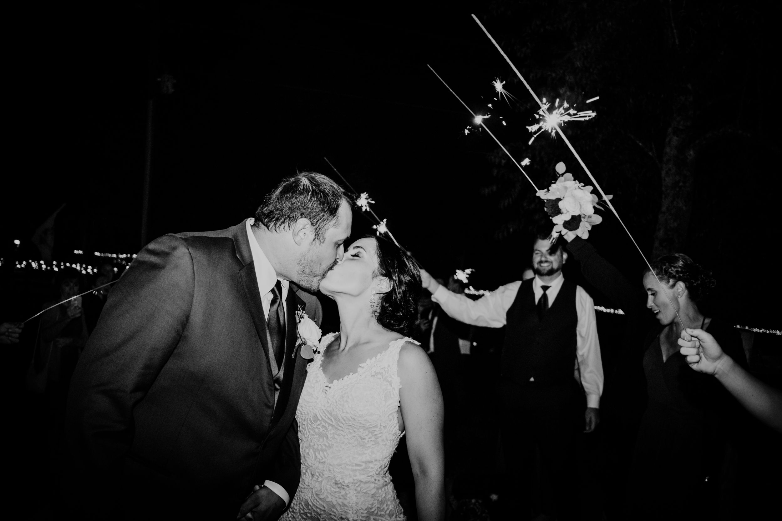 Newly married couple kissing, surrounded by sparklers at their wedding reception at Sorella Farms in Evington, Virginia.