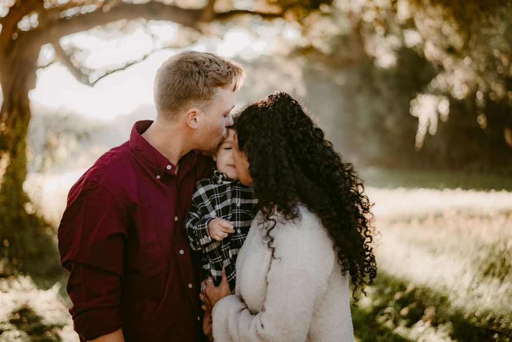 A romantic couple sharing a tender moment in golden sunlight.