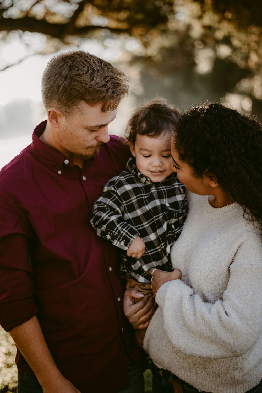 An intimate family moment captured in warm sunset lighting.