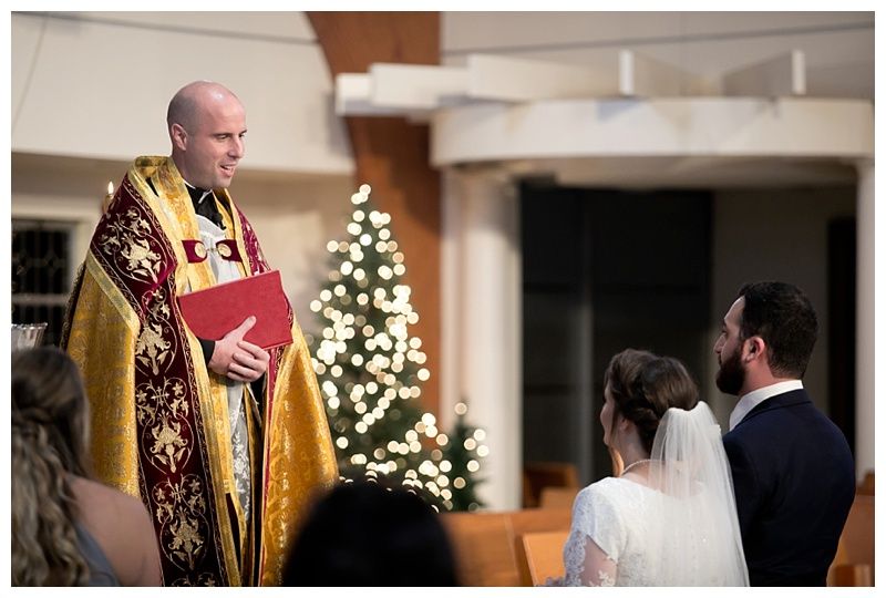 Wedding ceremony in progress with priest in gold vestments officiating at the altar.