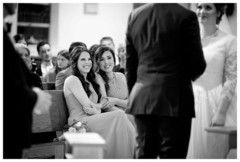 Wedding guests seated in church pews during the ceremony.
