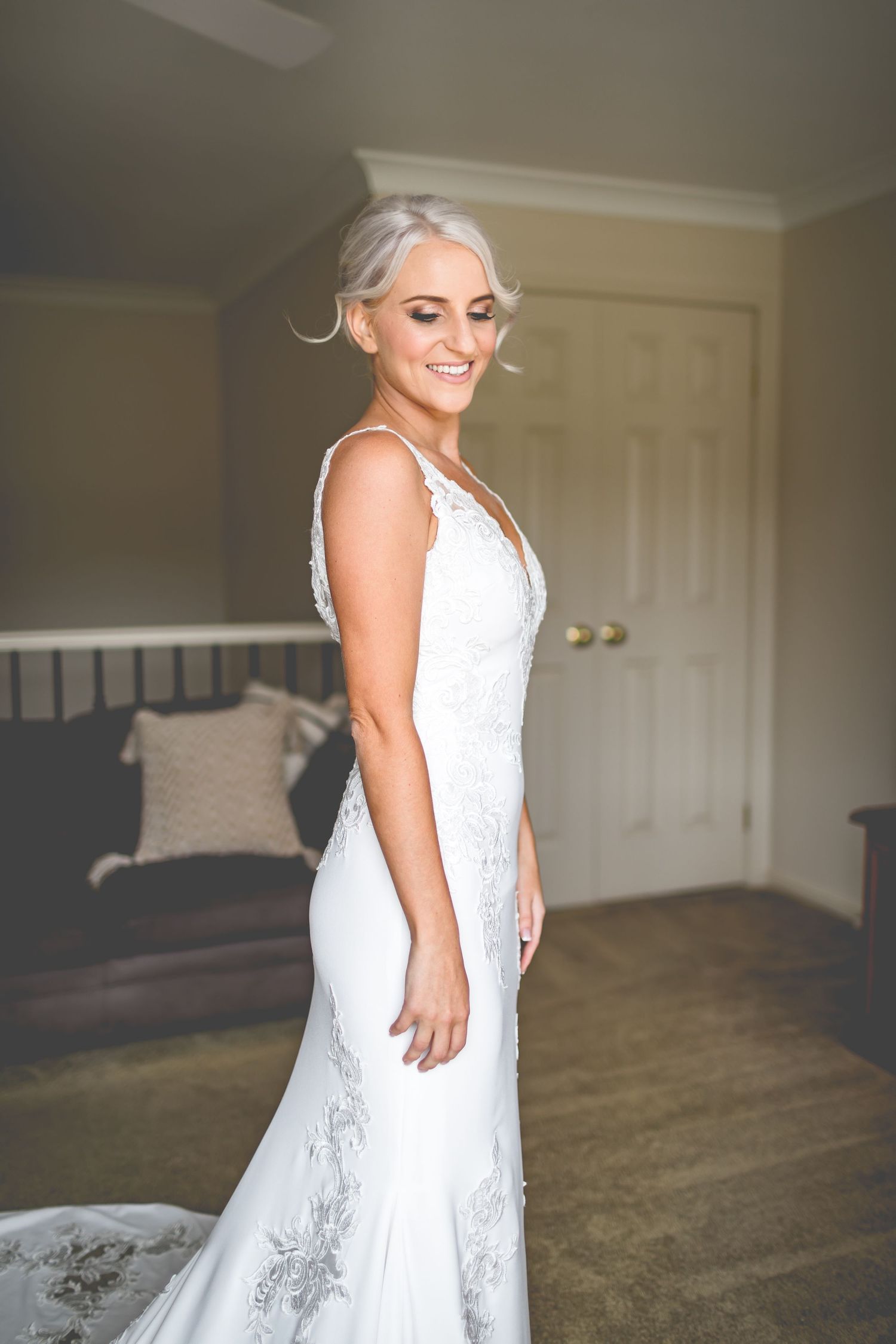 Beautiful wedding dress with intricate lace details in elegant indoor setting.