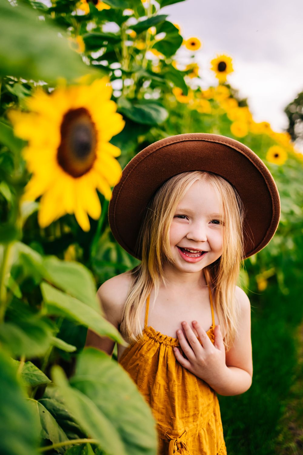A cheerful moment captured among tall sunflowers on a bright summer day.