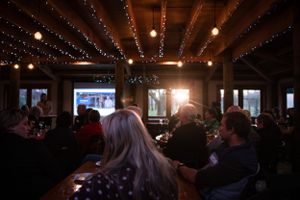 Dimly lit restaurant interior with string lights and people dining.