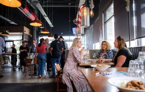 Casual restaurant interior with pendant lighting and customers dining at tables.