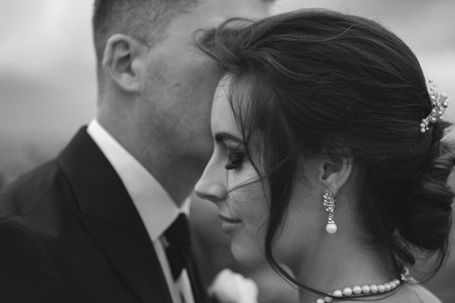 Black & White bridal couple intimate photos with bride's eyes closed and groom giving her kiss, Intiem Weddings Gauteng