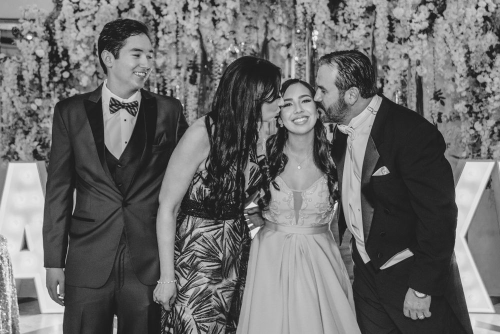 mother and father kissing daughter. XV photography