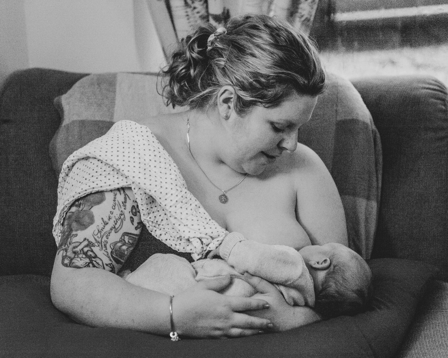 New born at home photo shoot with Cornwall new born photographer mum breastfeeding