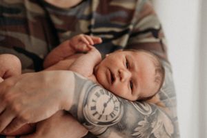 Newborn baby sleeping peacefully during professional photo session.