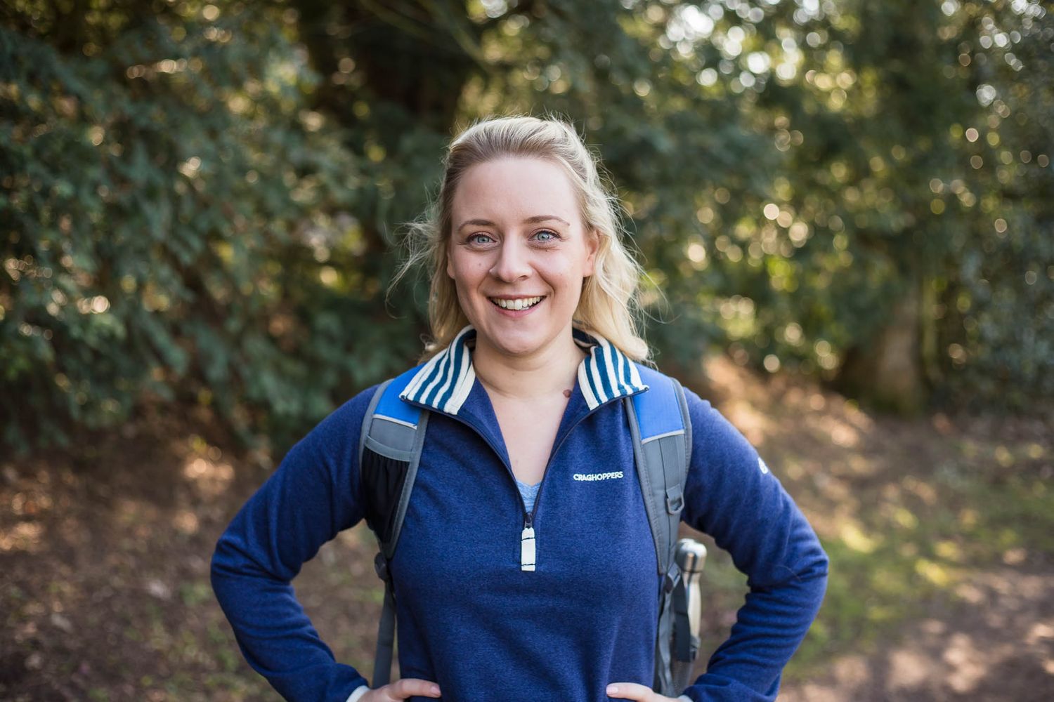 Image of Redditch photographer Holly Hancocks smiling at the camera wearing a backpack