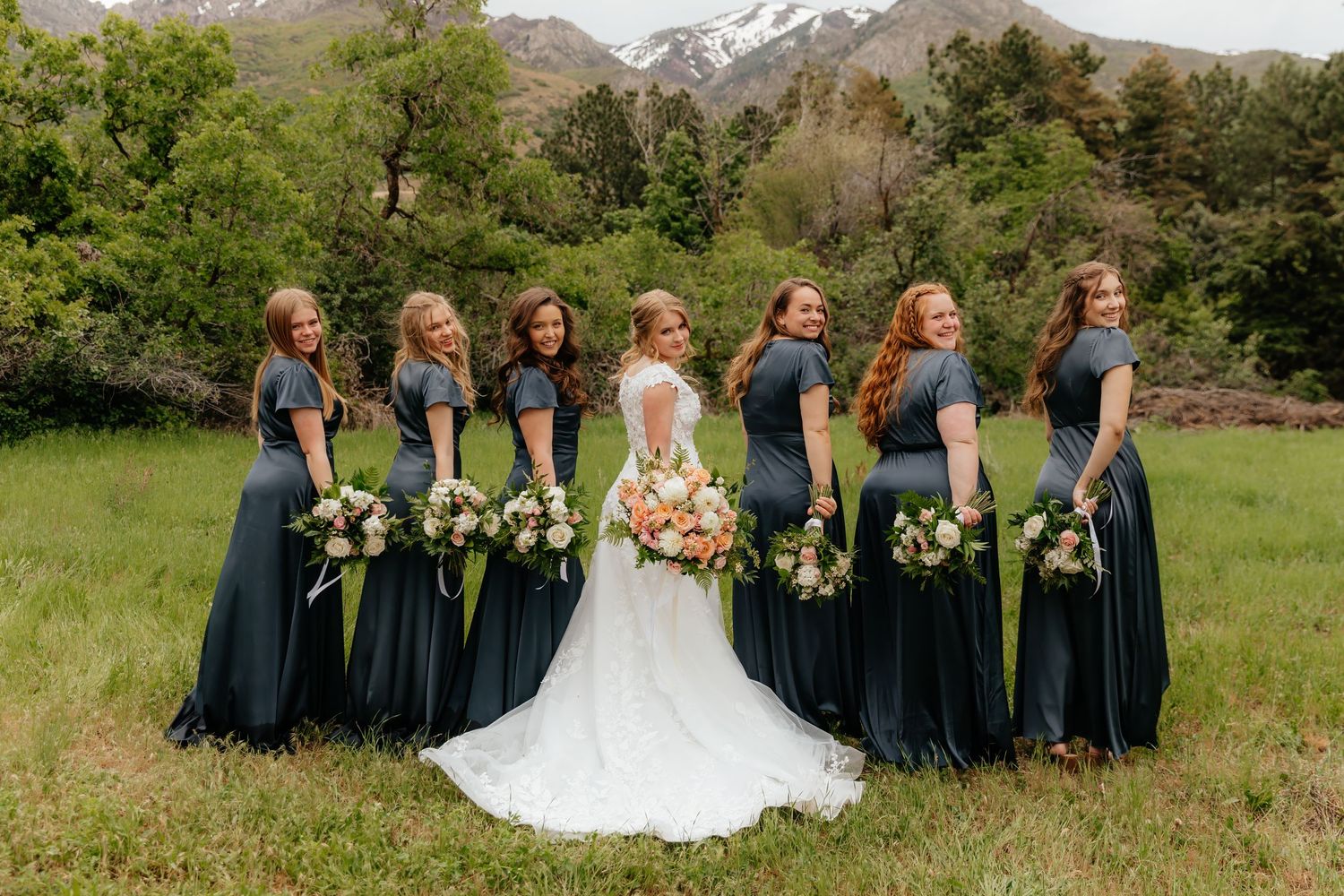 Bridesmaids and bride twisted around posing in Utah Mountain Wedding