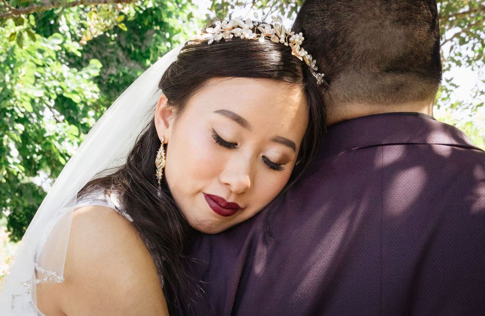 Close-up romantic wedding photos showing tender moments between a couple in an outdoor setting.