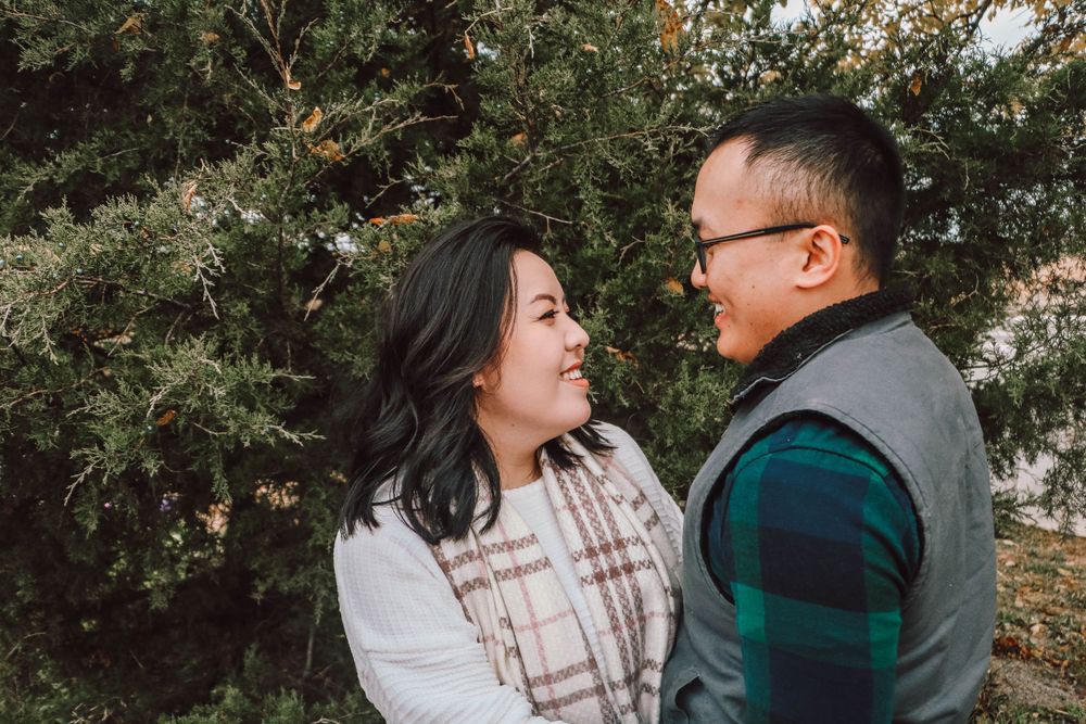 Romantic couple's portrait session among autumn trees and foliage.