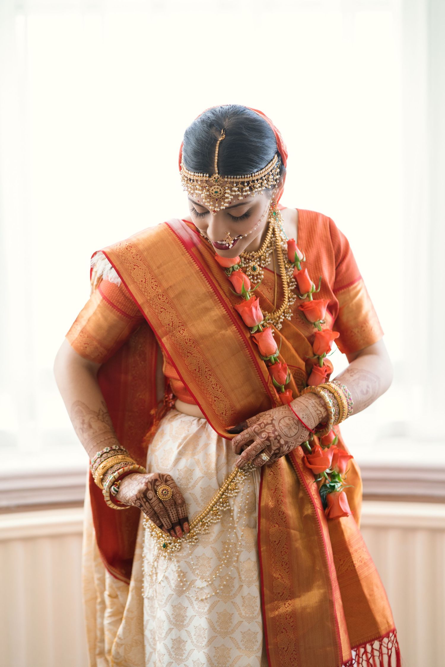 Escentric newly wed finishing her Vivāha portraying an outburst of emotions towards the photographers camera