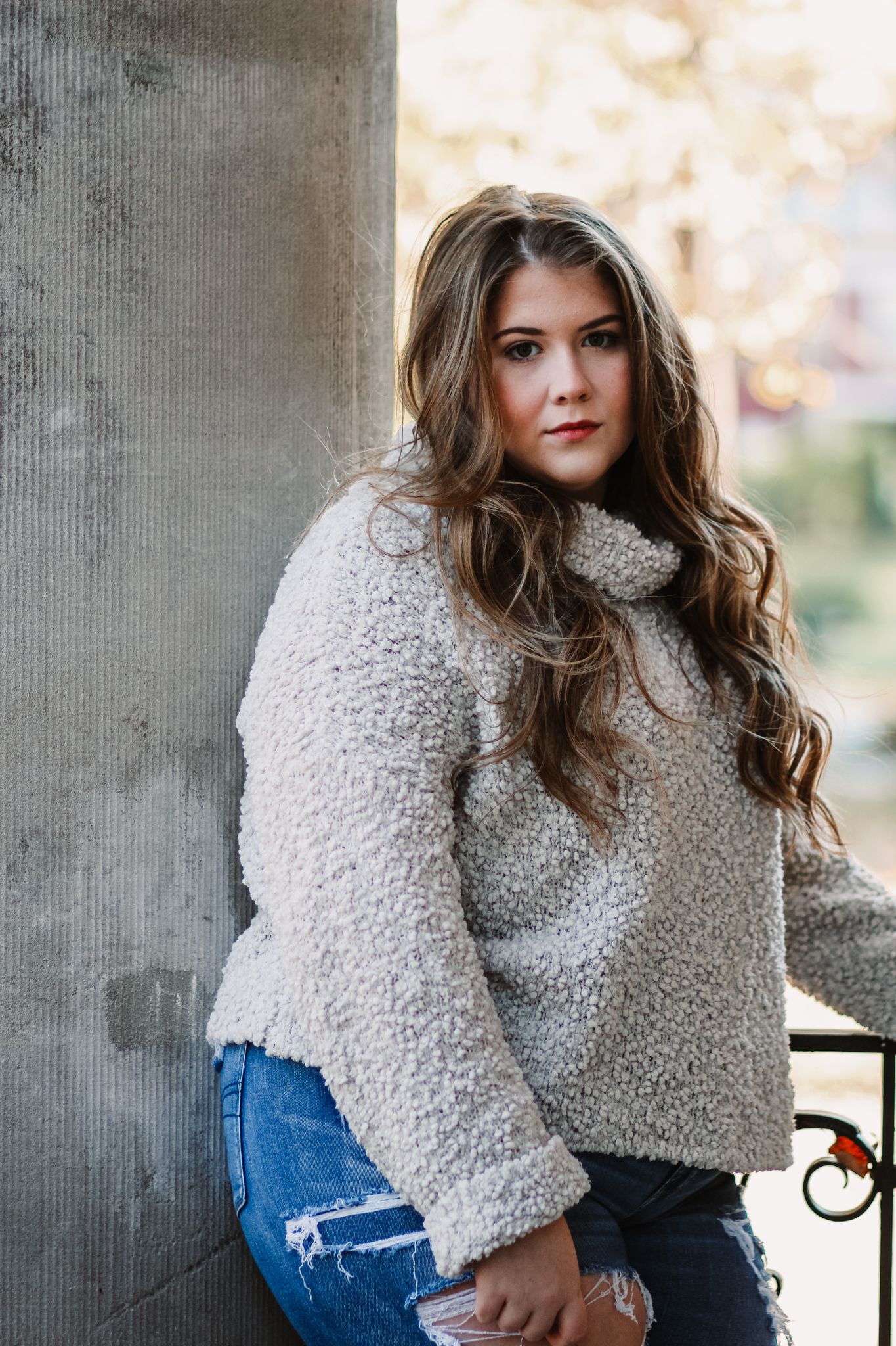 Fashion portrait series featuring a cozy sherpa sweater paired with distressed blue jeans.