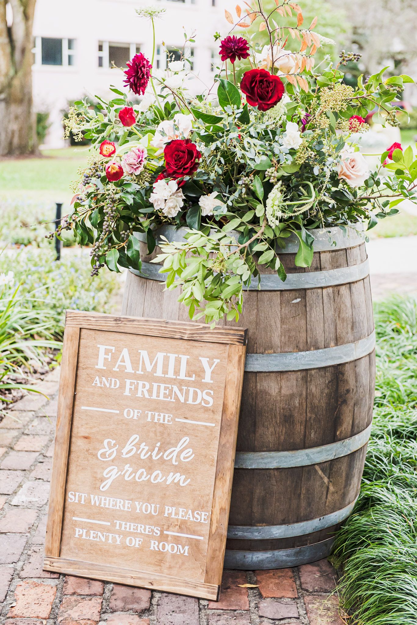 Beautiful wedding details feature a barrel with red and white roses at Casa Feliz Wedding Venue in Winter Park, FL.