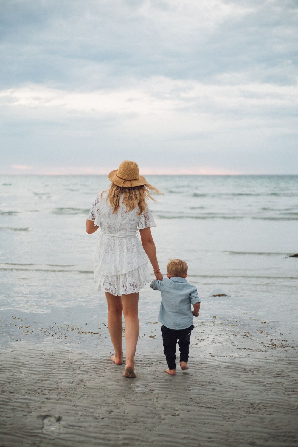 Victoria and her young son walking together towards the beach at Wallaroo North Beach