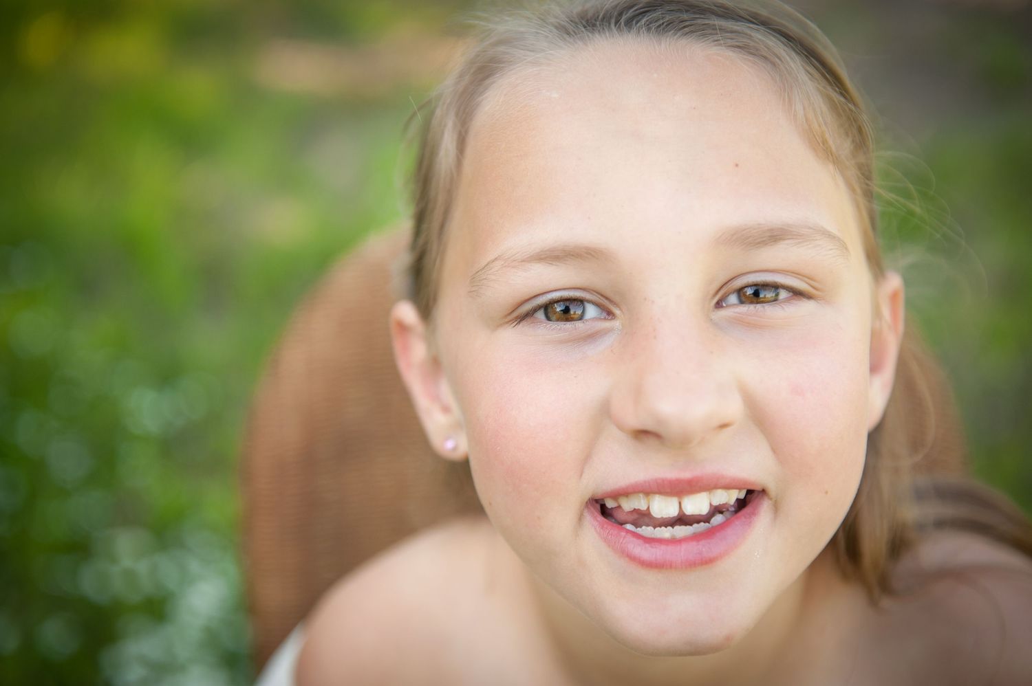 Outdoor portrait series with natural lighting and green foliage background.