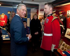 The King in the Guards Museum, Wellington Baracks, presenting a medal to a member of the Guards Band.