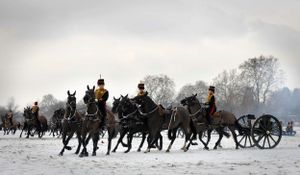 Kings Troop RHA carry out a 21 Gun Salute in Hyde Park during a cold, snowy winter morning.