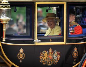 HM Queen enjoying a laugh in her carriage.