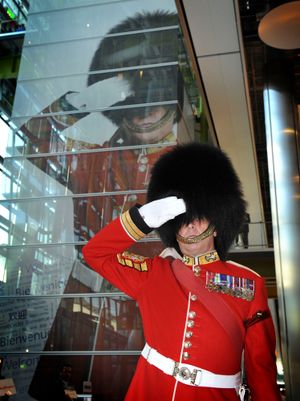 The Garrison Sergeant Major, Bill Mott, Salutes beneath his large portrait at Heathrow T5.