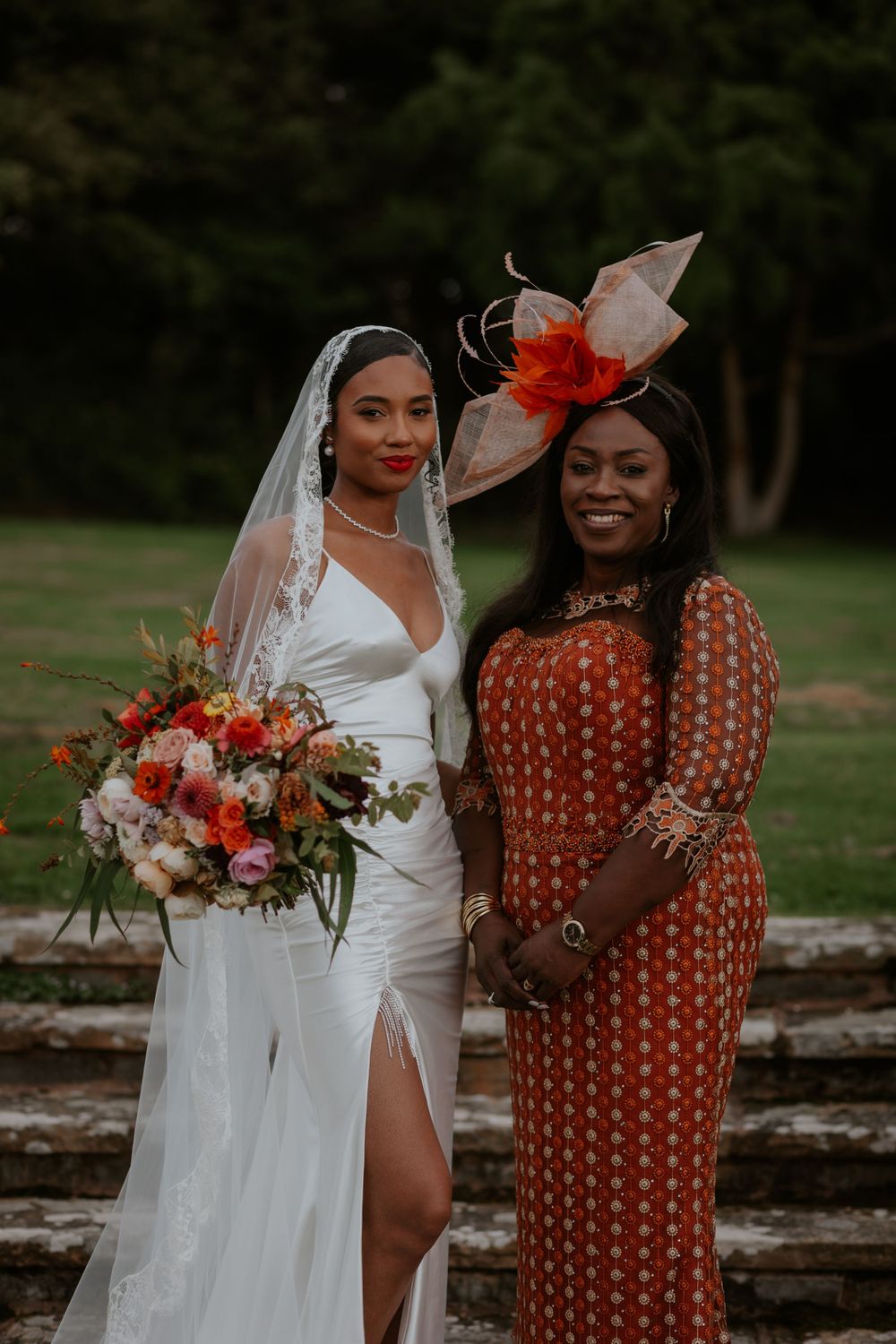 Elegant outdoor wedding portrait featuring stunning bouquet and fashion-forward attire.