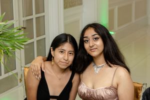 Party guests posing together at an elegant indoor venue with decorative lighting.