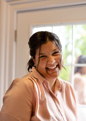Woman in pink shirt reacting with excited expressions in a series of candid photos.