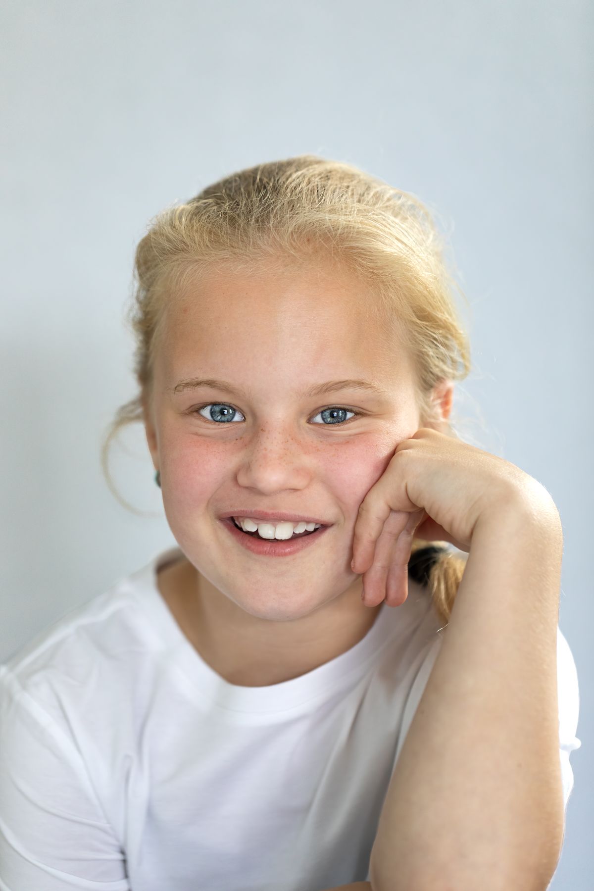 Kinderportret lachend meisje tegen witte achtergrond, Kinderportetfotografie, Barbara Kempeneers Fotografie
