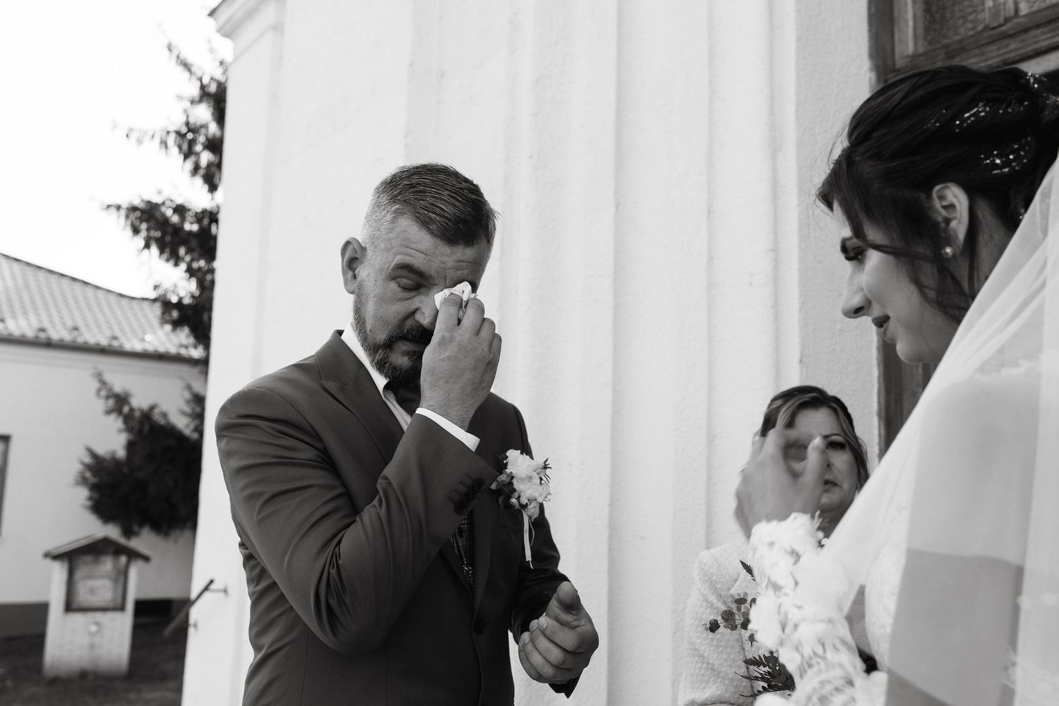 An emotional black and white moment captured during a wedding ceremony.