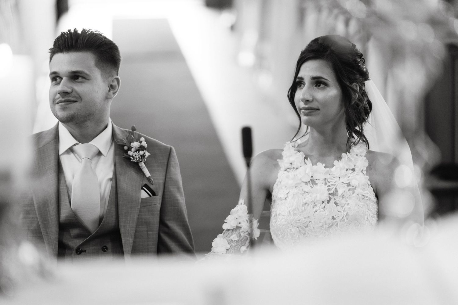 A black and white portrait of newlyweds during their church wedding ceremony.
