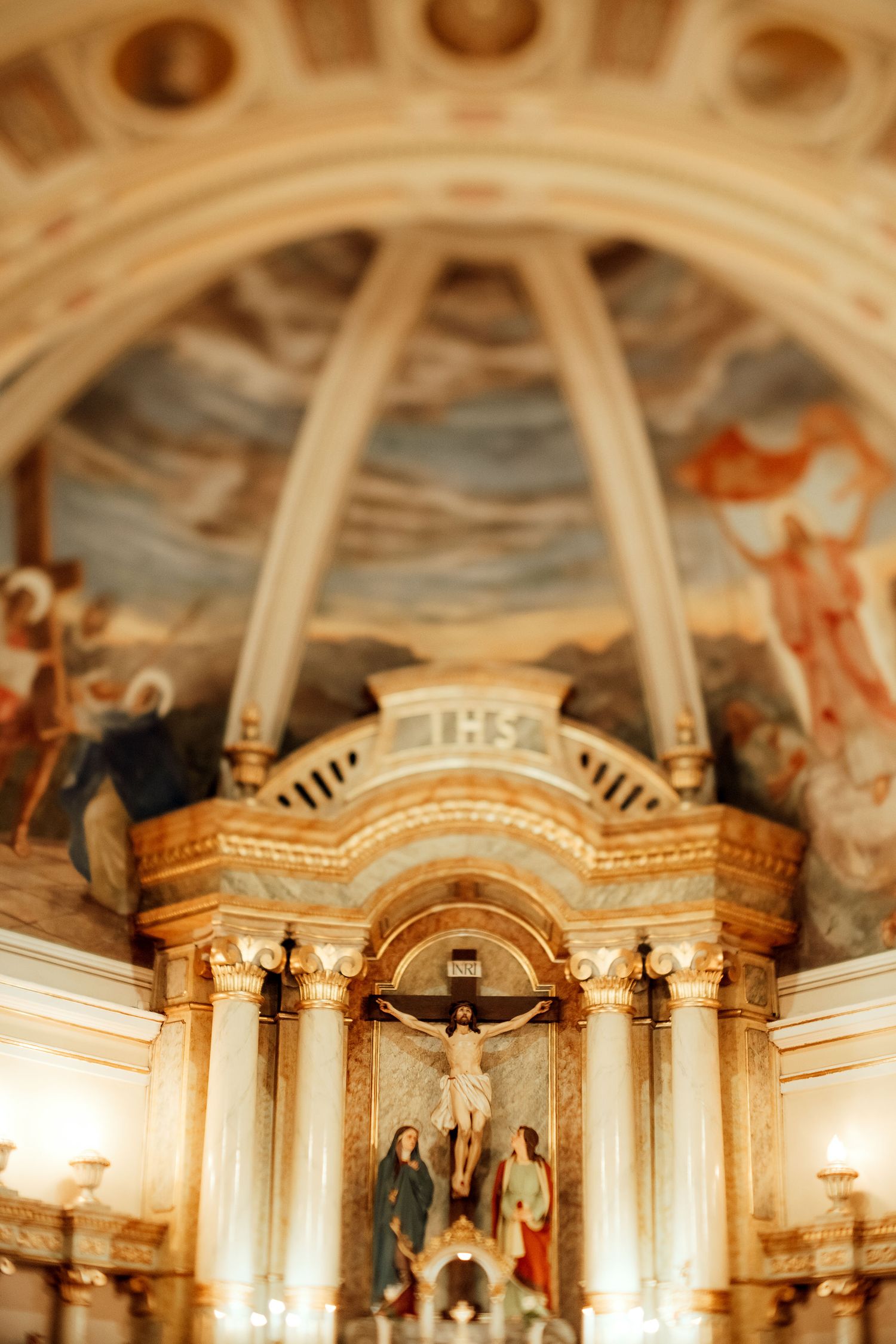 Ornate church altar ceiling with religious paintings and architectural details.