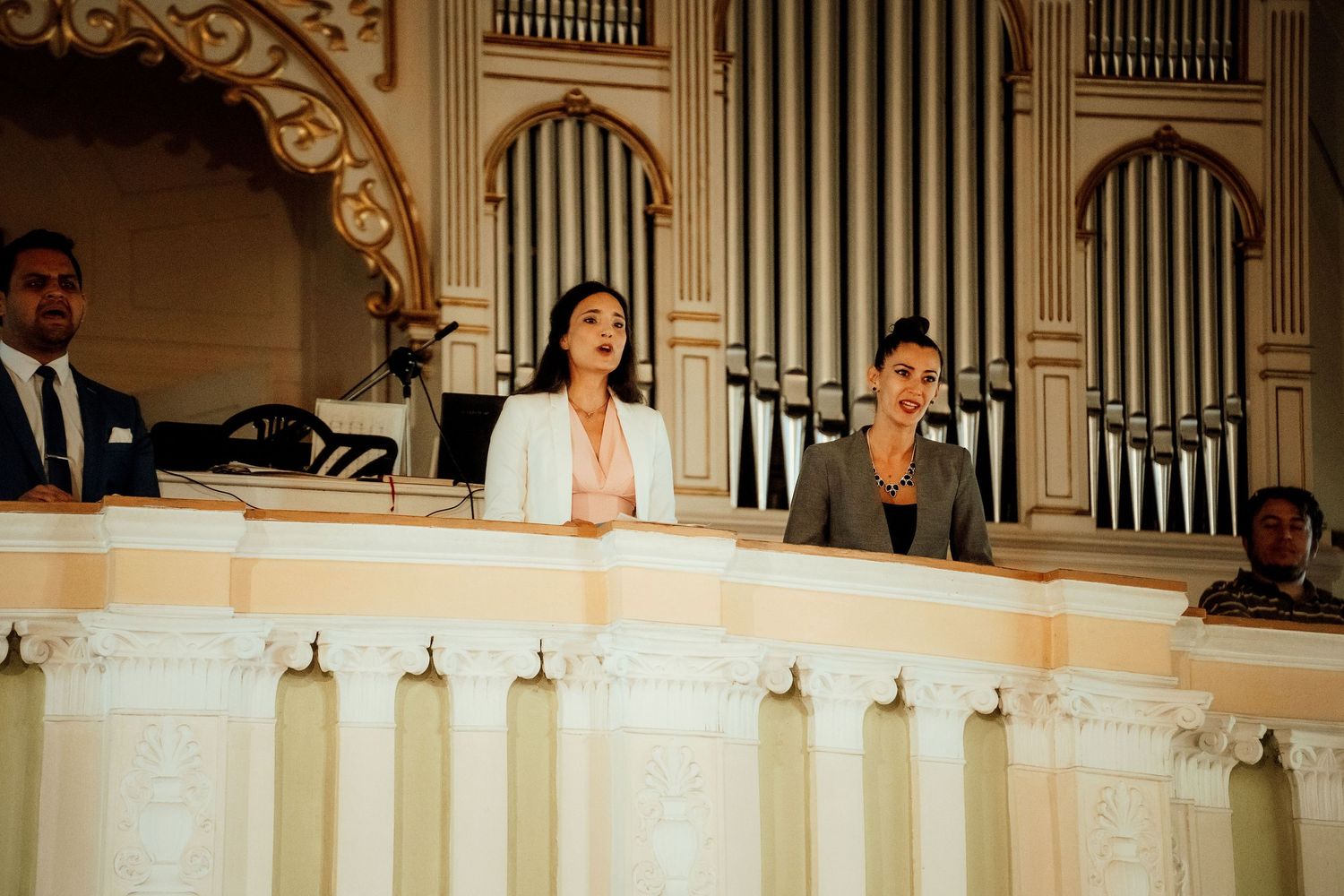Musicians perform from the church balcony during a wedding ceremony.
