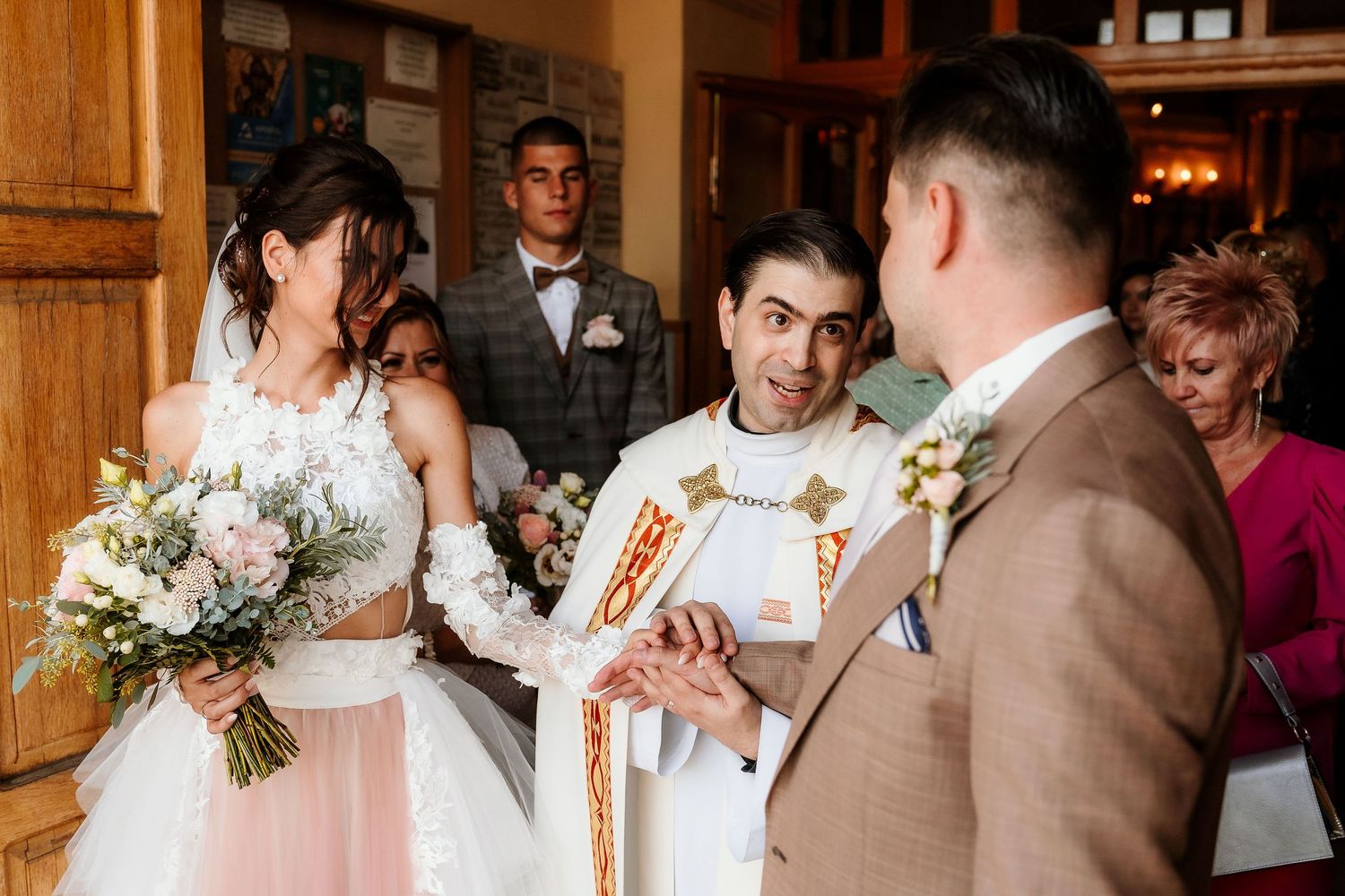 Religious wedding ceremony in progress with elegant floral decorations and formal attire.