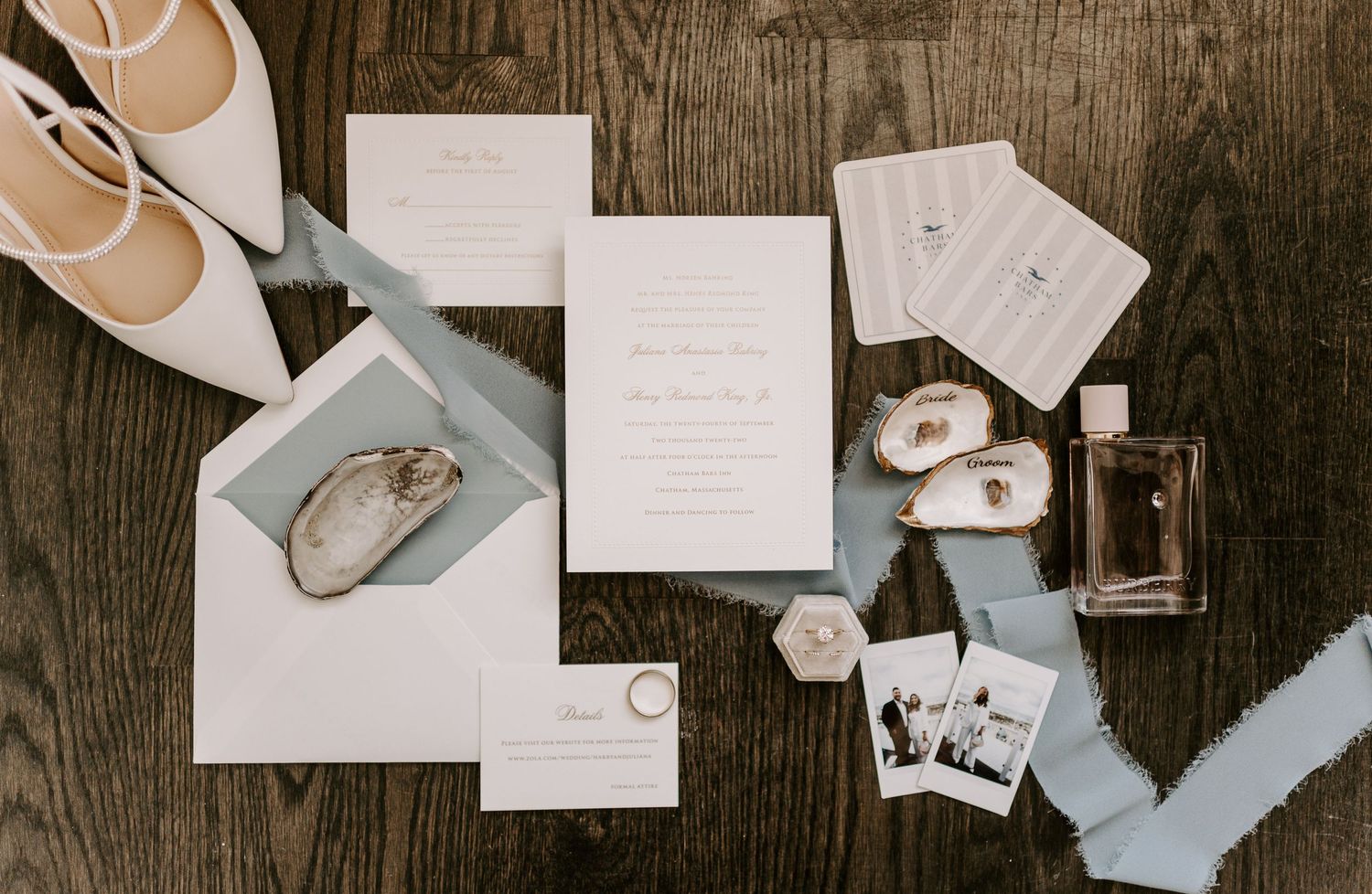 Wedding stationery and accessories arranged on a rustic wooden background.