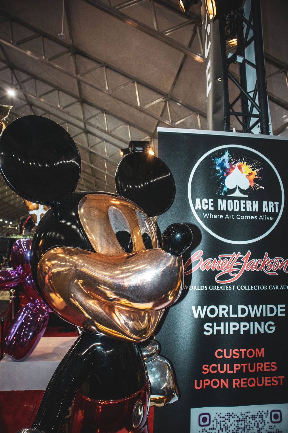 Metallic Mickey Mouse sculpture displayed at an ACE Modern Art exhibition booth.